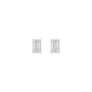 May include: A pair of stud earrings featuring emerald-cut diamonds. The diamonds are set in a white metal, likely platinum or white gold, and are displayed against a white background. The earrings are a classic jewelry item.