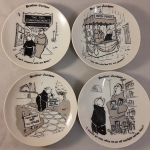 May include: Four white ceramic plates featuring Brother Juniper cartoons. Each plate has a different black and white illustration with text. The plates depict scenes with monks and humorous sayings.