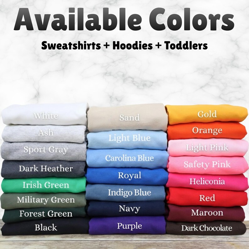 May include: Image showcasing a variety of folded sweatshirts and hoodies in various colors. The text "Available Colors" is at the top, with "Sweatshirts + Hoodies + Toddlers" below. Colors include white, black, red, orange, and more.
