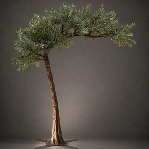 May include: A faux olive tree with a textured brown trunk and green leaves. The tree has a curved branch extending to the right. The base of the tree is secured to a metal base with four arms.