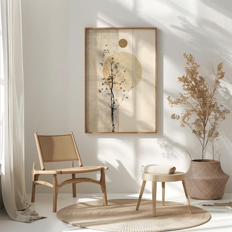 May include: A framed art print featuring a minimalist design with a tree silhouette and a large yellow circle. The artwork is in a wooden frame and hangs above a chair and a small stool. The color palette is neutral with beige and brown tones.