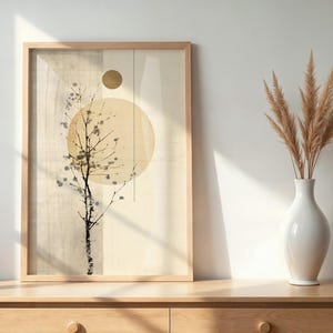 May include: A framed art print featuring a minimalist tree branch design with a large yellow circle and a smaller gold circle. The artwork is displayed on a light wood dresser, next to a white vase with dried pampas grass.