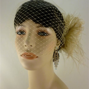 May include: A white birdcage veil with a feather accent. The veil is made of a fine mesh material and has a delicate, feminine look. The veil is perfect for a wedding or other special occasion.