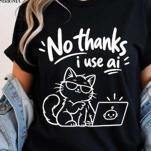 May include: A black t-shirt featuring a white graphic of a cat wearing sunglasses and sitting at a laptop. The text above the cat reads, "No thanks i use ai" in a bold, white, hand-lettered font. The laptop screen displays a small robot icon.