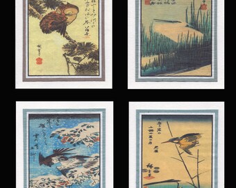 May include: Four framed Japanese woodblock prints. The prints depict birds, landscapes, and nature scenes. Each print has a white border and a colored frame. The prints feature a variety of colors, including blue, green, yellow, and brown.