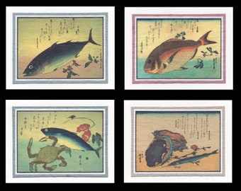 May include: Four framed art prints featuring Japanese-style illustrations of marine life. The prints depict various fish, a crab, and an oyster, each set against a backdrop of stylized waves and foliage. The artwork is framed with a neutral border.