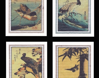 May include: Set of four Japanese woodblock prints featuring birds in natural settings. Each print has a unique composition, including a bird on a branch, a crane with a red sun, and birds in flight. The prints are framed with a white border and a gray trim.