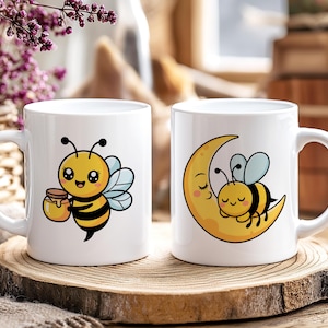 May include: Two white ceramic mugs with bee-themed designs. One mug features a cartoon bee holding a honey pot. The other mug shows a bee sleeping on a crescent moon. Both mugs have a white handle.