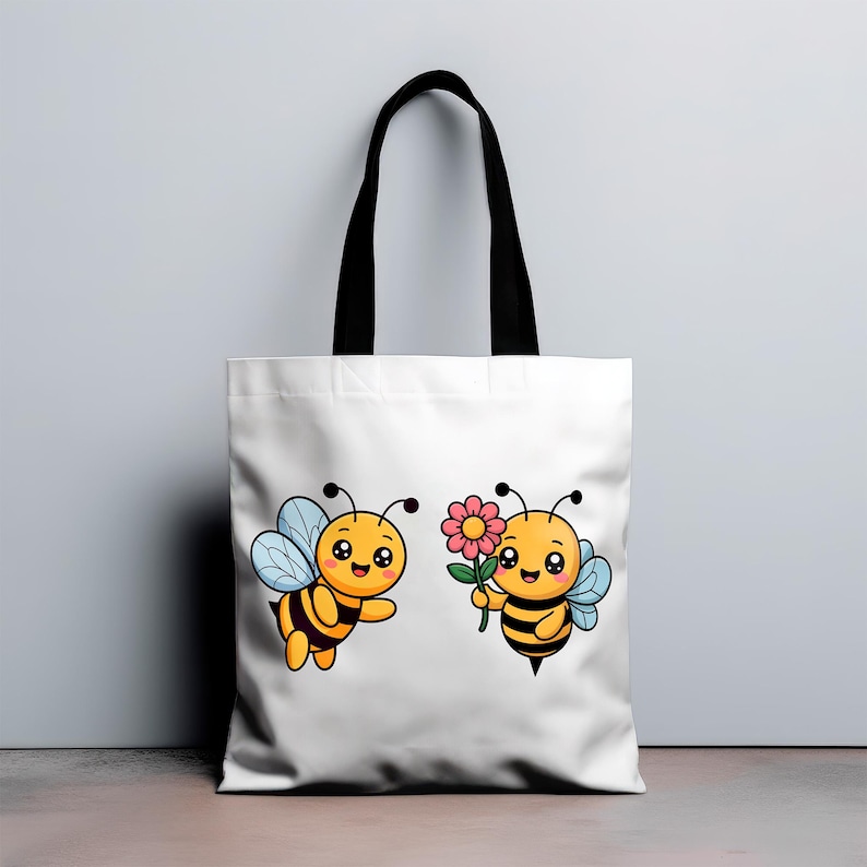 May include: White tote bag featuring two cartoon bees. One bee is flying with blue wings, and the other holds a pink flower. The bees are yellow and black with smiling faces. The bag has black handles.