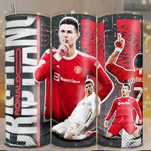 May include: A stainless steel tumbler featuring Cristiano Ronaldo in various poses. The tumbler has a black and white background with the name "Ronaldo" in large, bold letters. The design includes images of Ronaldo in red and white jerseys.
