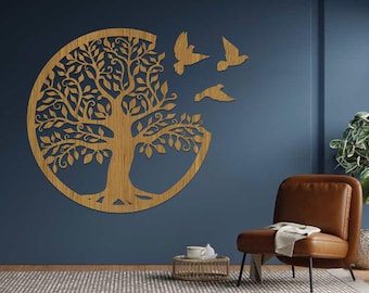 May include: A wooden wall art piece featuring a tree design within a circle, with three birds flying away. The artwork is a light brown color and is mounted on a dark blue wall. The tree has detailed leaves and branches.