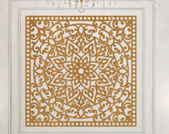 May include: A living room scene featuring a white sofa with black trim and decorative pillows. Above the sofa is a large, ornate, gold-colored wall art piece with a symmetrical design. The room is decorated with gold sconces and a chandelier.