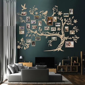 May include: A wooden family tree wall decoration featuring numerous photo frames, birds, and floral details. The tree is mounted on a dark teal wall, serving as a focal point in a living room. The frames contain various family photographs.