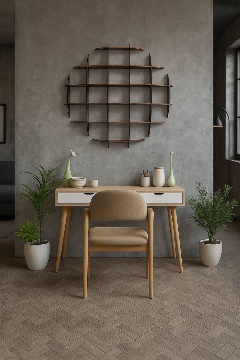 May include: A modern home office setup featuring a light wood desk with white drawers, a beige chair, and a circular wall shelf. Decorative vases and plants in white pots add a touch of nature. The room has a neutral color palette.