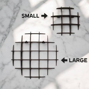 May include: Two dark brown, grid-like decorative objects, one labeled "SMALL" and the other "LARGE". The objects are placed on a white marble surface. The "SMALL" object is smaller than the "LARGE" object.