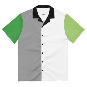 May include: A short-sleeved button-down shirt with a color-block design. The shirt features a black collar, a gray left panel, a white right panel, and green sleeves. The shirt has black buttons and a small logo on the collar.