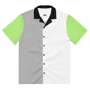 May include: A short-sleeved button-down shirt with a color-blocked design. The shirt features a black collar, a gray left panel, a white right panel, and lime green sleeves. The shirt has black buttons and the text "PRINT POSSUM" on the collar.