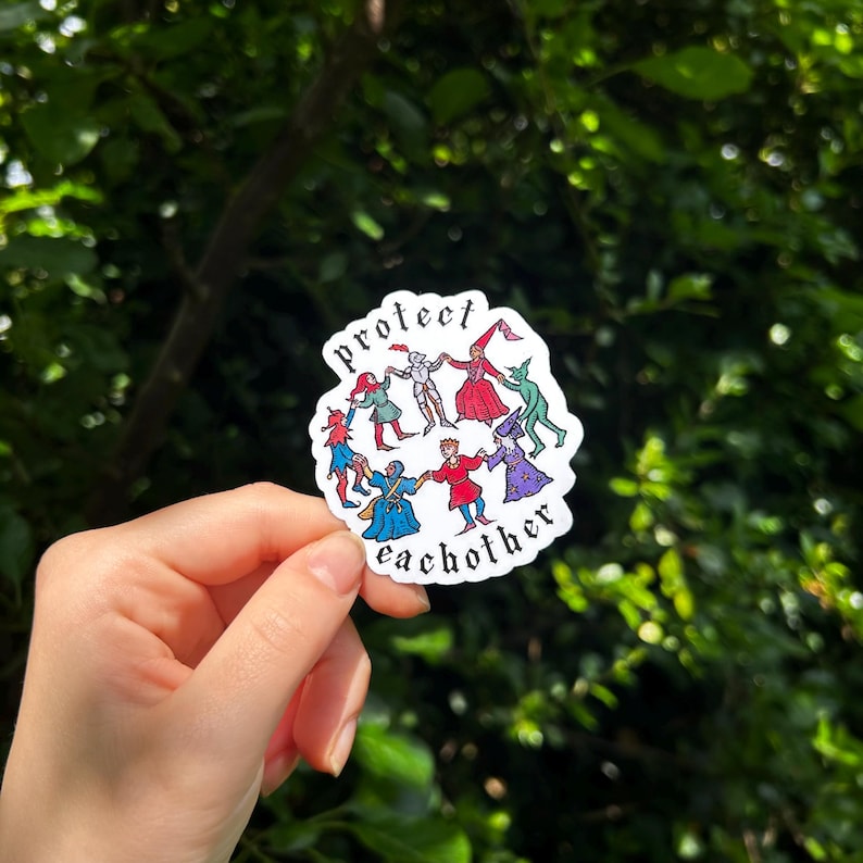 May include: A die-cut sticker featuring a circular illustration of diverse fantasy characters holding hands in a ring, including a knight, a wizard, and a jester. The text "protect eachother" is printed in black gothic font along the top and bottom.