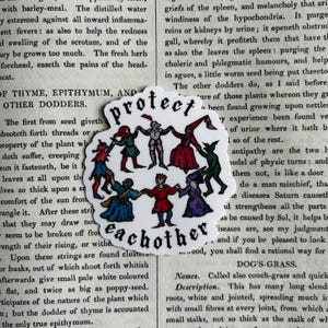 May include: A die-cut sticker featuring a circular illustration of seven diverse medieval-style figures holding hands in a ring. The text "protect eachother" is printed in a black gothic font above and below the figures in a white background.