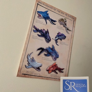 May include: A poster titled "Megalodons of the Sea of Thieves" displaying illustrations of different shark-like creatures. Each creature is labelled with a name. A small white sticker with blue border and text "SR Design Creations" is in the lower right corner.