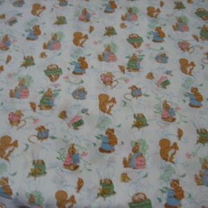 May include: White fabric with a repeating pattern of cartoon squirrels, rabbits, and mice wearing clothing. The animals are in various poses, surrounded by pink flowers and blue swirls. The fabric has a vintage, whimsical feel.