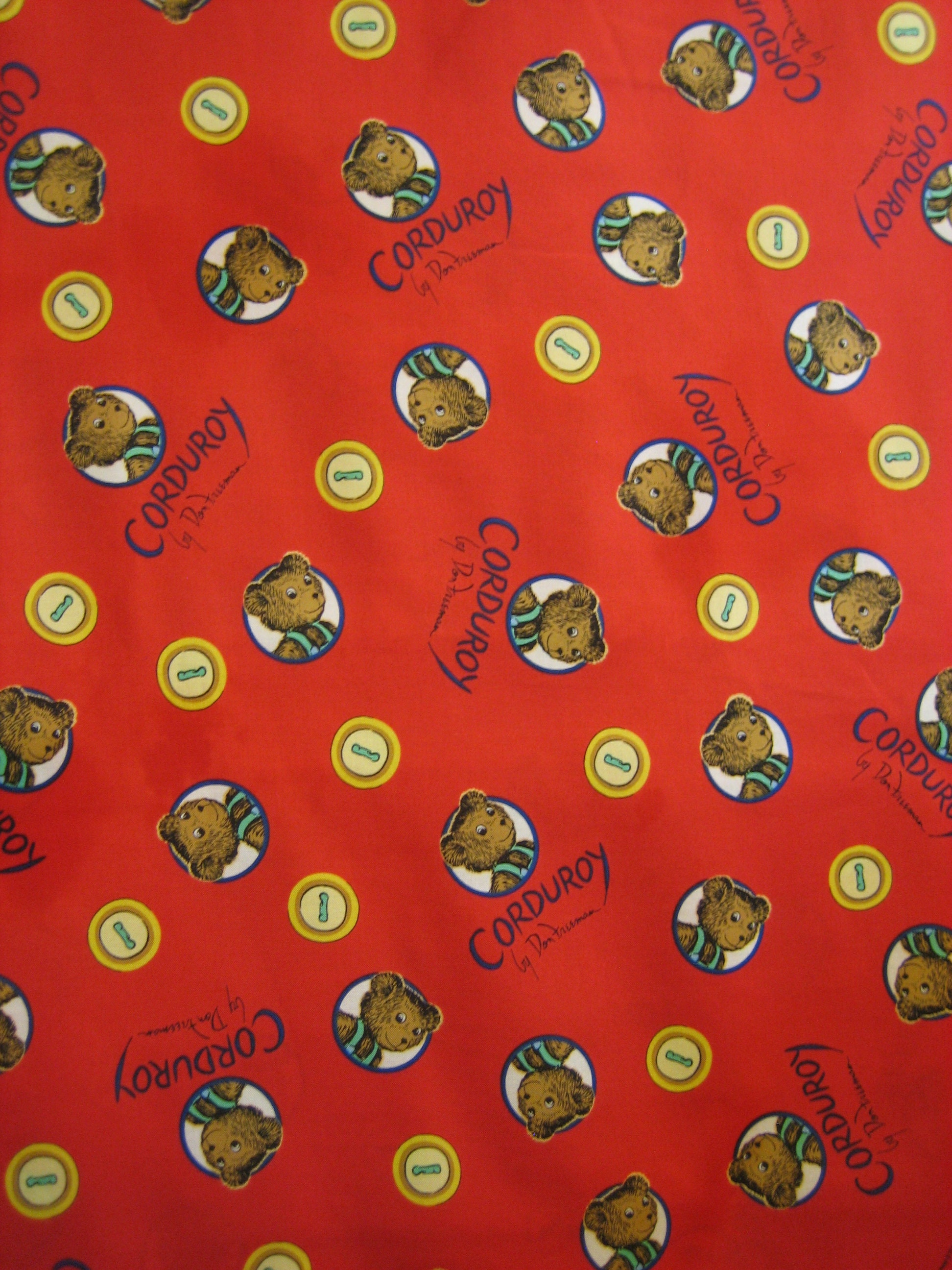 Corduroy the bear tossed faces on red with yellow buttons (Cloud 9 )  2016  ( 18 x 44 inches )