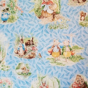 Beatrix Potter characters on blue background Quilting Treasures fabric ( 17 x 44 inches )