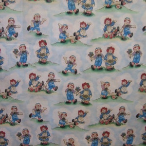 Raggedy Ann and Andy playtime  ( Daisy Kingdom # 4510 ) outside on grass ( 18 x 44 inches )