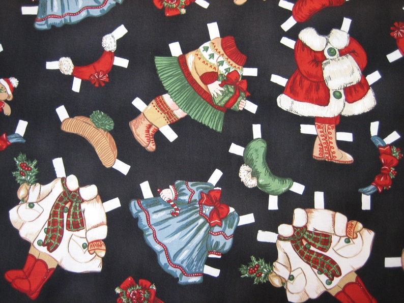 May include: A black fabric featuring a repeating pattern of Christmas-themed paper dolls. The dolls are dressed in festive outfits, including coats, dresses, and hats, with red, green, and white accents. The paper dolls have white tabs.