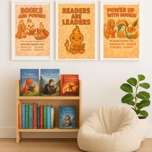 May include: Three framed posters with the text "BOOKS ARE POWER!", "READERS ARE LEADERS", and "POWER UP WITH BOOKS!". A wooden bookshelf displays colorful books, including "Eleanor Cavn Hoston" and "Theodore". A beige beanbag chair and a potted plant complete the scene.