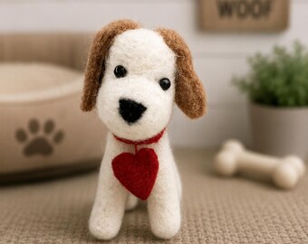 May include: A needle-felted dog figurine with white fur, brown ears, and black eyes. The dog wears a thin red collar with a prominent red heart-shaped pendant hanging from the center. The figure is crafted from soft wool fibers with a textured finish.