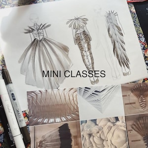 May include: A sketchbook page with fashion design sketches in black ink on white paper. The sketches are of three different outfits, each with a unique silhouette and detail. The text "MINI CLASSES" is written in black ink at the bottom of the page.