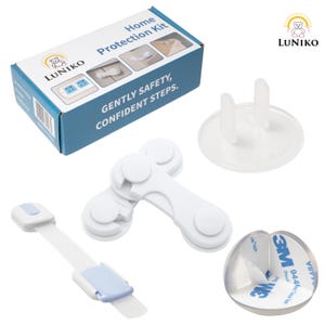 May include: A LUNIKO Home Protection Kit box with blue and white packaging, featuring child safety items including white plastic cabinet locks, a clear outlet plug cover, and a transparent corner guard with 3M adhesive backing.