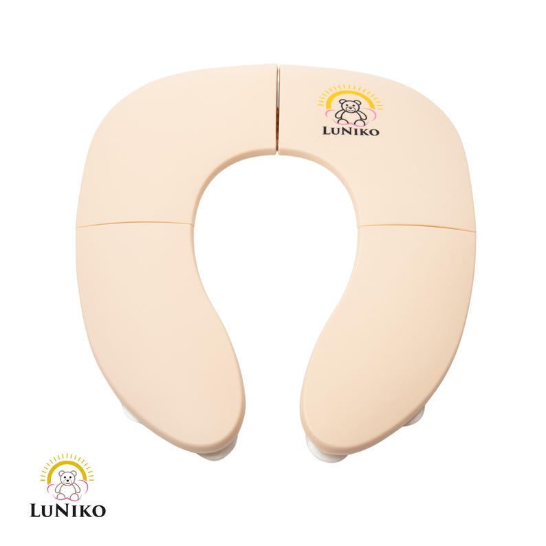 May include: A beige, U-shaped foldable toilet seat cover with a smooth finish. The top right section features a logo with a bear illustration, a yellow sunburst, and the text LUNIKO. The same logo appears in the bottom left corner of the image.