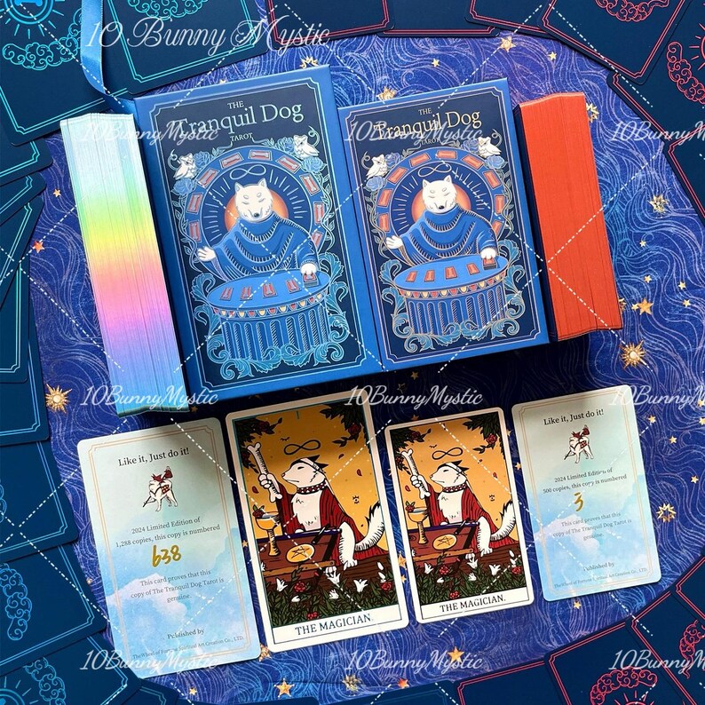 May include: A tarot deck set titled The Tranquil Dog featuring two blue boxes with a dog illustration, a stack of holographic-edged cards, a stack of orange-edged cards, and two cards labelled The Magician and Like it, Just do it! with number 638.