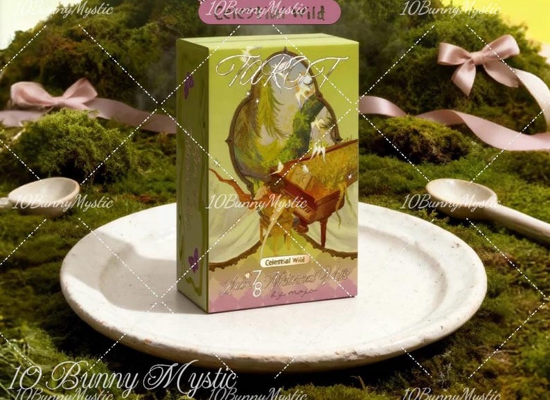 May include: A green and pink tarot card box with the words "Tarot" and "Celestial Wild" visible. The box features an illustration of a figure with a musical instrument. The box is on a white plate.