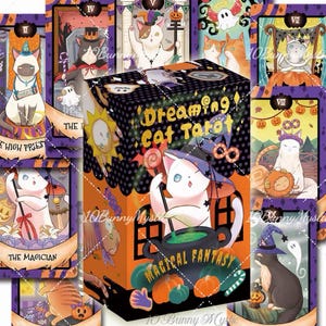 May include: A deck of Dreaming Cat Tarot cards featuring a central box with a white cat wearing a witch hat stirring a green potion in a black cauldron. The box displays the text Dreaming Cat Tarot and Magical Fantasy with orange pumpkins.