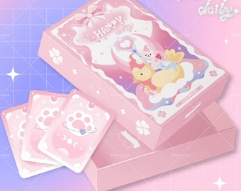 May include: A pink box set with the text "Happy daily" and a cartoon illustration. The set includes a box, a lid, and several pink cards with paw print designs. The background is a gradient of pink and purple.