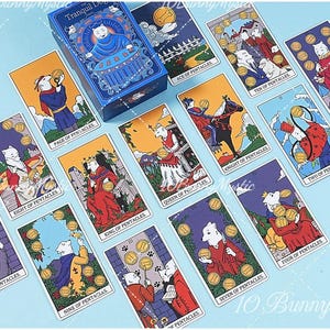 May include: A deck of tarot cards titled The Tranquil Dog, featuring illustrations of white dogs in various scenes. The cards include the Ace, Two, Four, Five, Six, Seven, Eight, Nine, Ten of Pentacles, plus the Page, Knight, Queen, and King of Pentacles.