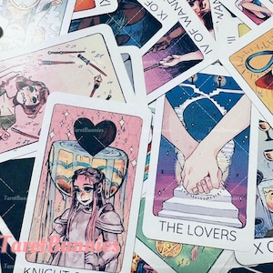 May include: A selection of tarot cards with diverse illustrations and text. The cards display images of figures, symbols, and text, including "THE LOVERS" and "IX OF WANDS". The colour scheme incorporates pink, blue, and gold.