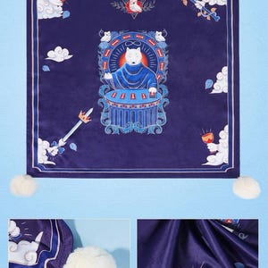 May include: A square dark blue altar cloth featuring the text FLUFFY BALL ALTAR CLOTH, decorated with white pom-poms at each corner. The central graphic depicts a white wolf in a blue robe at a table, surrounded by clouds, a sword, and a goblet.