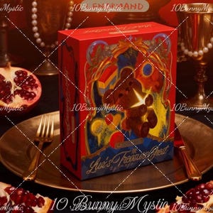 May include: A red gift box with a teddy bear illustration and the text "Luv's Treasure Chest" sits on a gold plate with a fork and knife. A halved pomegranate and a gold goblet are in the background.