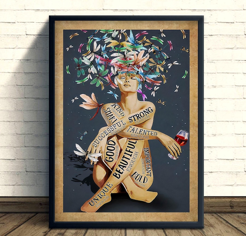 May include: Framed art print depicting a seated figure with a head of colourful butterflies and dragonflies. Text on the figure reads "Kind, Smart, Successful, Good, Beautiful, Unique, Strong, Talented, Important, Bold, Enough." The figure holds a glass of red wine.