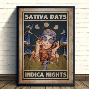 May include: A framed poster with the text "SATIVA DAYS" and "INDICA NIGHTS". The artwork features a woman wearing sunglasses and a headband, surrounded by mushrooms and celestial elements. The color palette includes blues, browns, and greens.