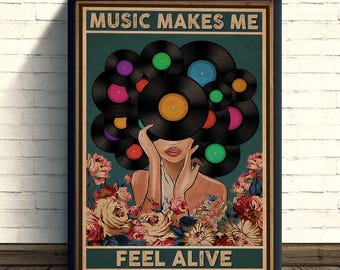 May include: A framed poster with the text "MUSIC MAKES ME FEEL ALIVE." The artwork features a woman with vinyl records in place of hair, surrounded by colorful flowers. The records have various colored labels.