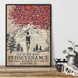 May include: A framed art print featuring a woman standing before a mountain range, with a tree adorned with colorful leaves. The text "LET US RUN WITH PERSEVERANCE" is displayed below the image, with the Bible verse Hebrews 12:1.