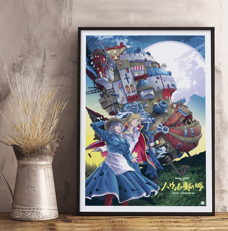 May include: Framed art print with a vibrant anime illustration. The image shows characters standing before a large, detailed, moving castle, set against a full moon. Japanese and English text is included in the design.