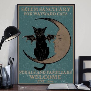 May include: Framed poster with the text "Salem Sanctuary for Wayward Cats" and "Ferals and Familiars Welcome". It depicts a black cat with bat wings on a crescent moon with a face. The background is teal, with a vintage aesthetic.