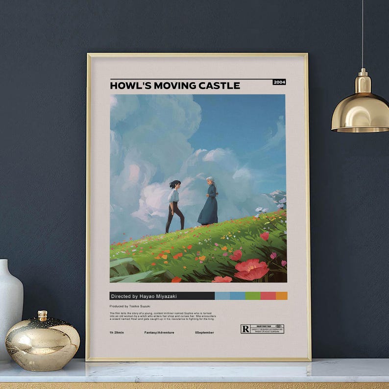 May include: A framed poster featuring the animated film "Howl's Moving Castle." The artwork depicts two figures on a grassy hill with a blue sky and clouds. The poster includes the film's title, director's name, and release year.