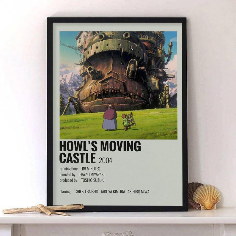 May include: Framed poster featuring the animated film "Howl's Moving Castle." The artwork depicts the castle, characters, and text. The poster is in a black frame and includes the film's title, year, and credits.